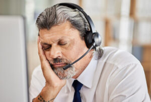 Tired man wearing a headset.